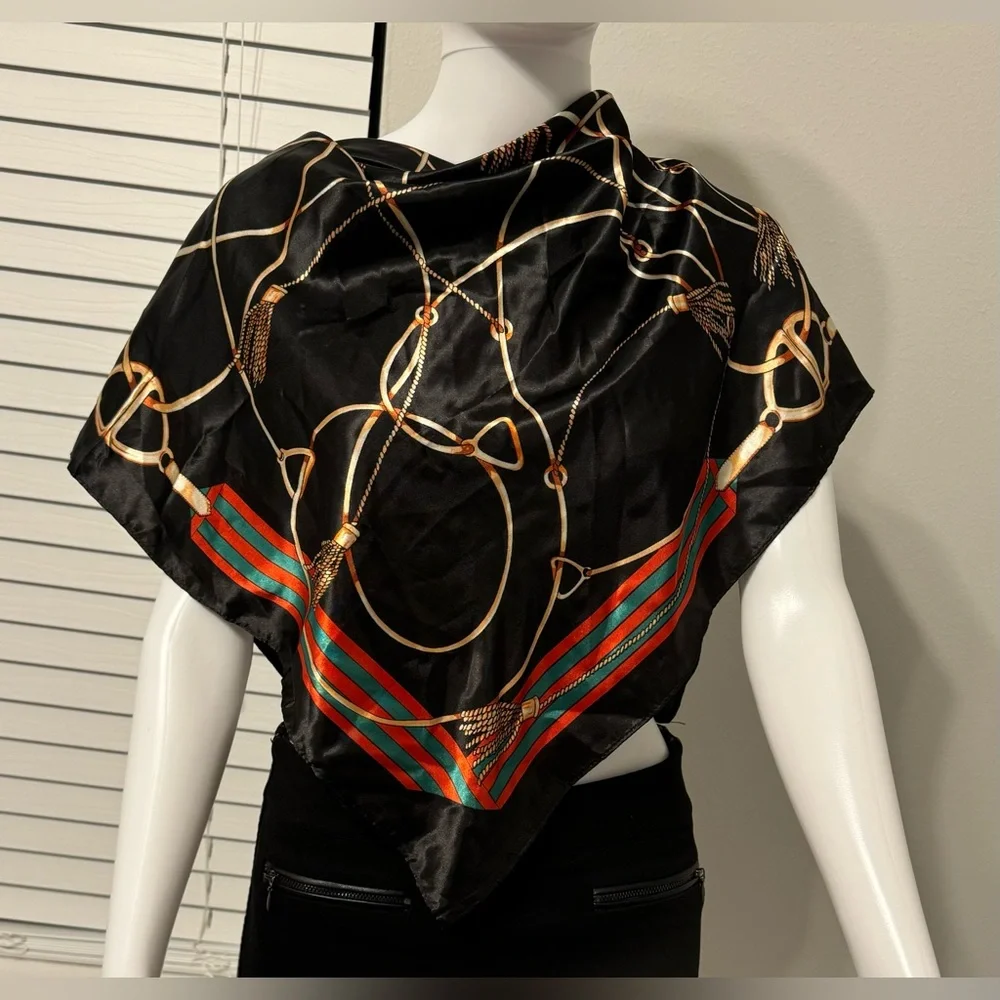 Fashionable women's black scarf with a chain and print. Polyester.
